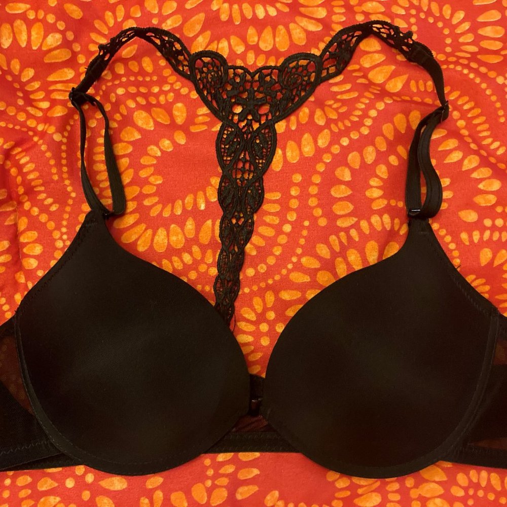 Black bra with decorative straps.